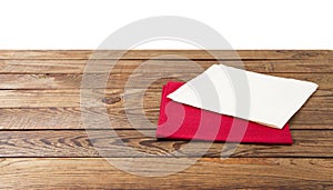 Red Napkin. Tablecloth tartan, checkered, dish towels on white wooden table background top view closeup