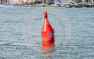 Red navigational bouy showing where to pass