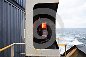 Red navigational light on the port side of the vessel