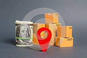 Red navigational location designator, cardboard boxes and a Roll bundle of dollars. Business and commerce. Local economy