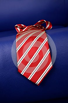 Red necktie on the blue sofa