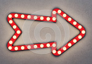 Red neon arrow on a concrete background