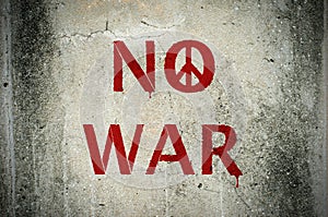 Red No War message and peace symbol graffiti on grunge ciment wa photo