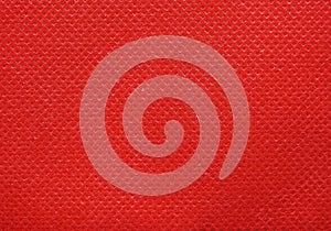 Red nonwoven polypropylene fabric texture background