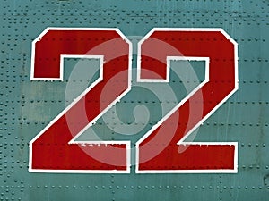 Red 22 numbers on aircraft fuselage close up.