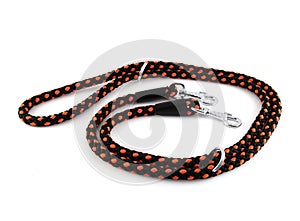 Red nylon dog lead or leash isolated on white background. The leash is red and black and has two carabiners