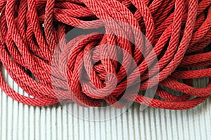 Red Nylon rope texture background on white napery