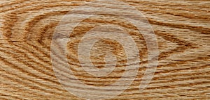 Red oak wooden floor board with knot in close up format