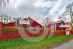 Red ochre painted colour wooden houses