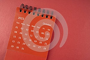 A Red Ocotber 2023 desk calendar for the organizer to plan and reminder on red background