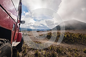 Red off road car at Mount Bromo, Indonesia, adventure trial