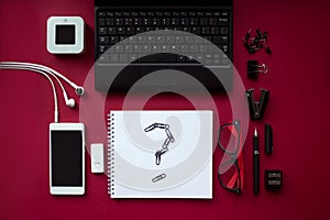 Red office desk top view with stationery, computer accessories and noteboo with question. Corporate stationery branding. Bussines