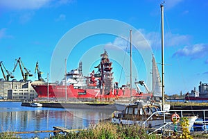 Red offshore and supply ship being repaired in shiprepairing yard