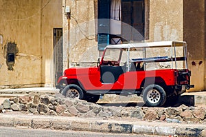 Red old car parked on the street, Dahab Egypt