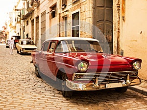 Red old and classical car in road of old Havana Cuba