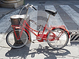Red old fashioned bicycle parked street