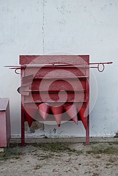 Red fire shield against a white wall background