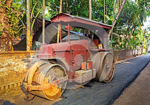 Red old heavy road roller