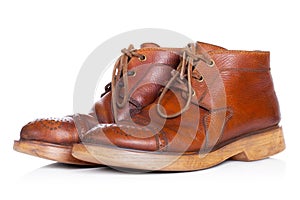 Red old leather boots isolated on white background