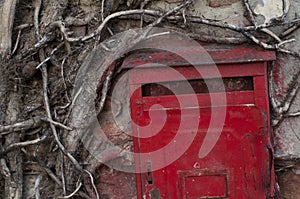 Red old mailbox on the wall. Letter boxes
