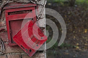 Red old mailbox on the wall. Letter boxes