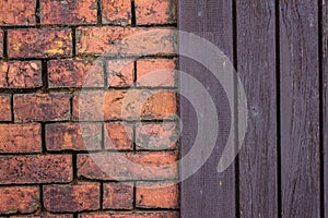 Red old rustic brick wall and old brown wooden housewall