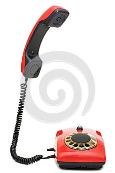 Red old telephone over white