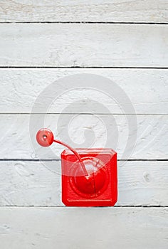 Red old vintage mechanical coffee grinder on white wooden