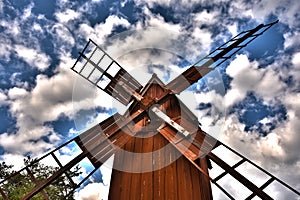 A red old windmill made in wood