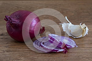 Red onion and garlic clove on wood