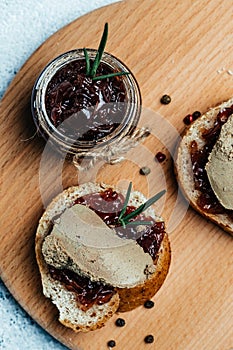 Red onion marmalade jam confiture in jar. Vegetable jam on dark background. Delicious sauce. French cuisine. Food recipe