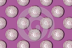 Red onion rings seamless pattern isolated on purple background.