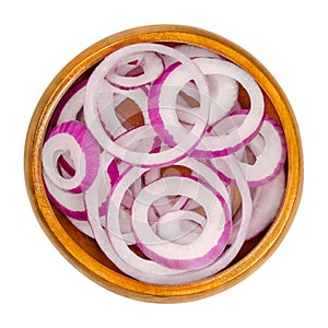 Red onion rings in a wooden bowl