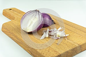 Red onion slices on chopping board isolated on white background