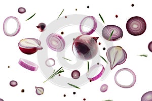 Red onion, whole, halves, slices and rings with rosemary and multi colored peppers flies and levitates in space. Volumetric light