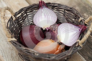 Red onions in a basket with knife
