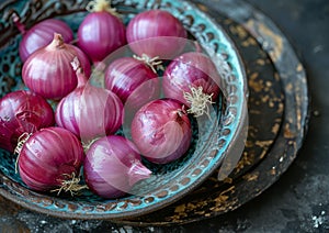 Red onions in blue bowl on dark background
