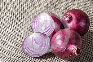 Red onions on jute background