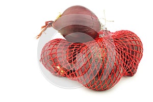 Red onions in a red plastic net