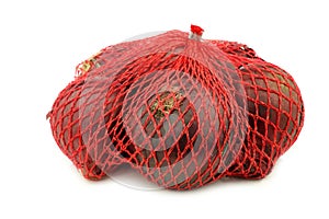 Red onions in a red plastic net
