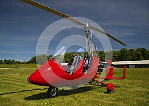 Red open-cockpit autogyro