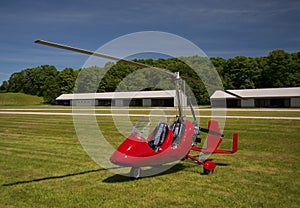 Red open-cockpit autogyro