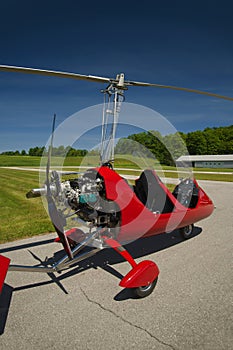 Red open-cockpit autogyro