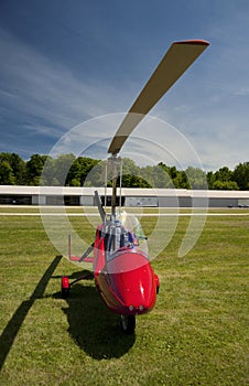 Red open-cockpit autogyro