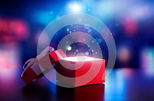 Red open gift box with magical light