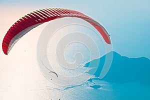 Red open parachute in the blue sky. Oludeniz, Mugla. Summer and vacation background