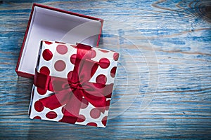 Red opened gift box on wooden board holidays concept