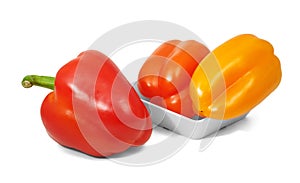 Red and orange bell pepers in horizontal position on white backg