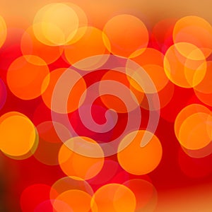 Red and orange bokeh lights of Christmas garland. Blurred background.