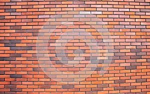 Red and orange brick wall of a building, construction and industrial background, stone